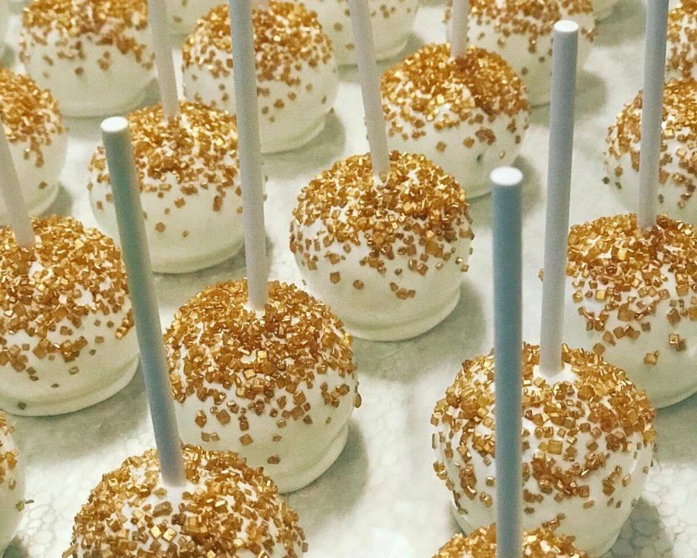 white cake pops with gold sprinkles